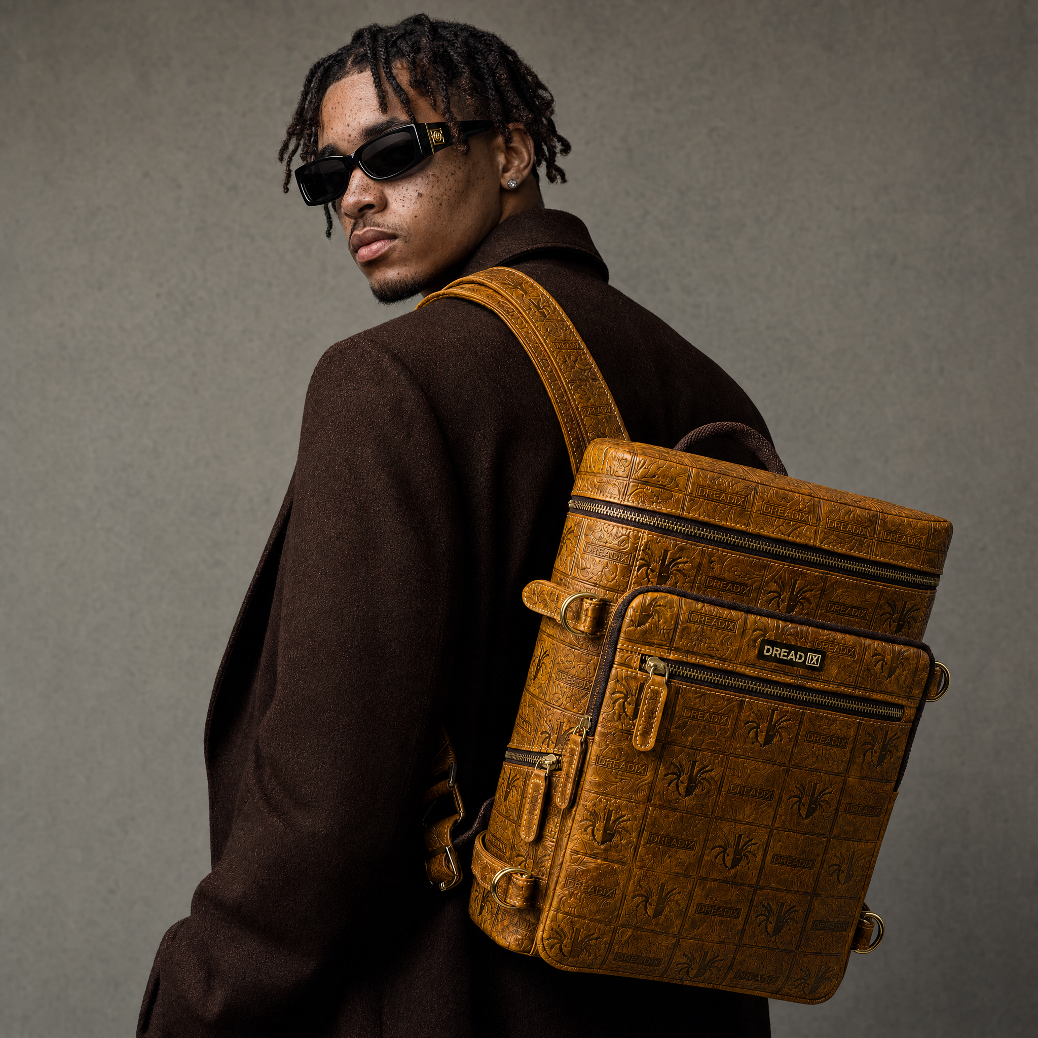 Model presenting the yellow DREAD IX backpack in a warm studio look